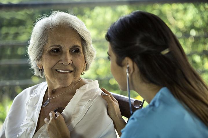 Physician listens to her senior patient's heart Physician listens to her senior patient's heart