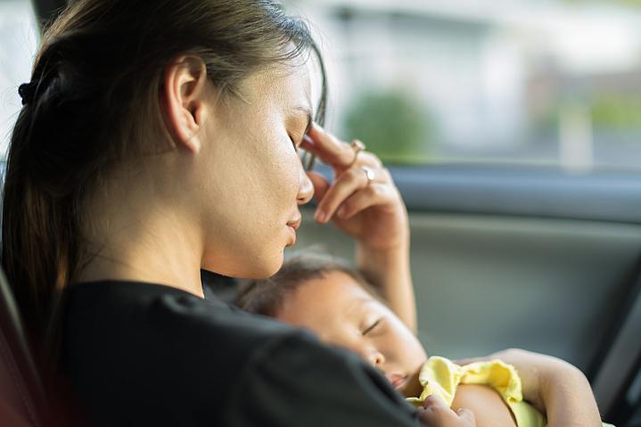 Stressed mom trying to nap with her baby in the car Stressed mom trying to nap with her baby in the car